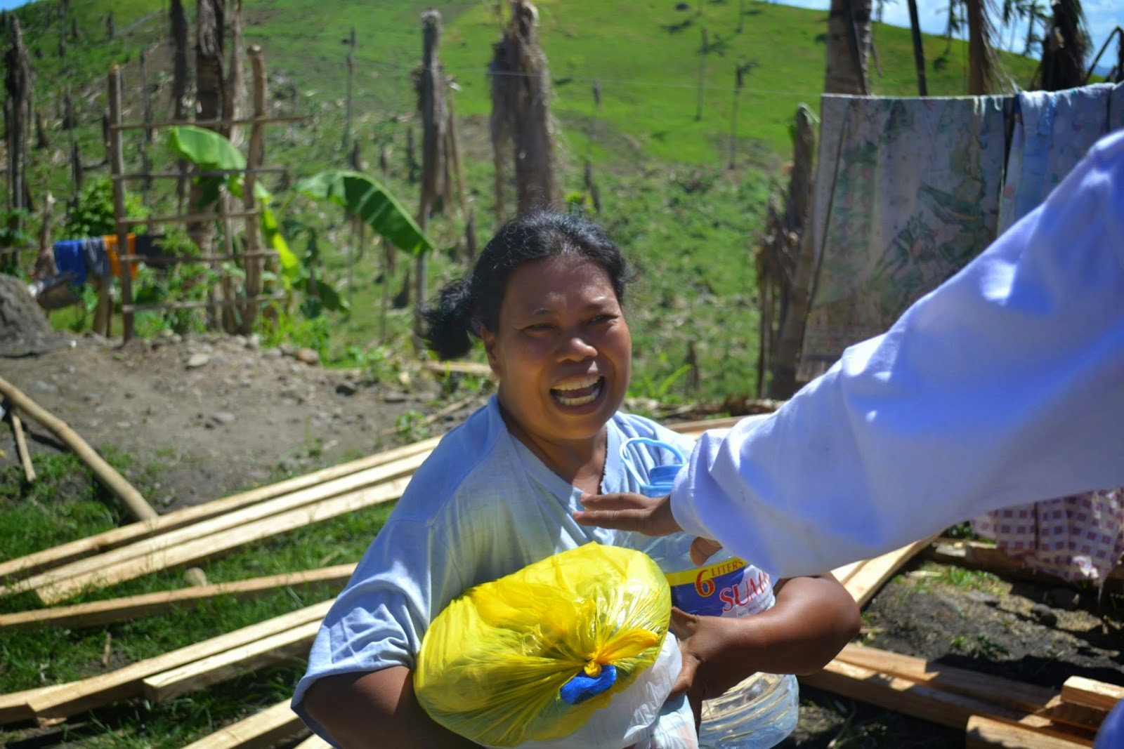Sharon passing out food and supplies from the back of the truck.