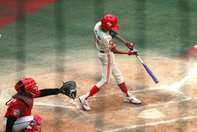 Austin slams the ball high and far just out of reach of the right fielder. By the time the ball hits the ground, Austin is rounding second.