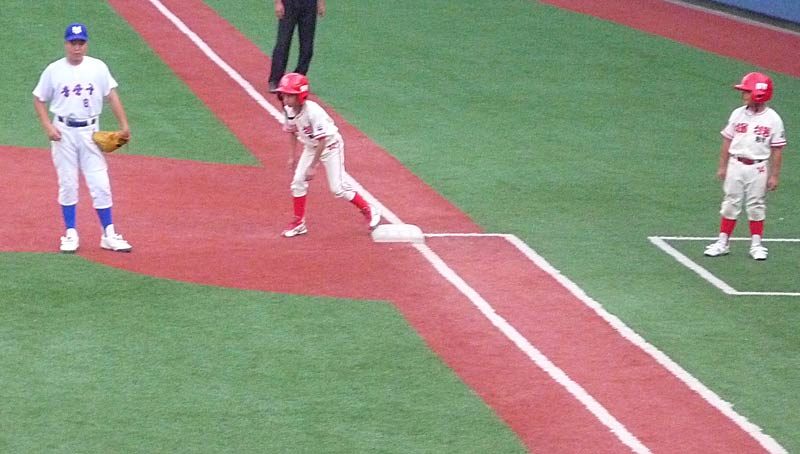 …I watch as Adam floats above first base with unimaginable pride…broadcast all over Korea…now he is locked ’n’ loaded and ready to steal second…a shining moment for him…the Coach…the team…and all those who attended that day. We witnessed and were part of something rare and special…a turning point in a little boy’s life.