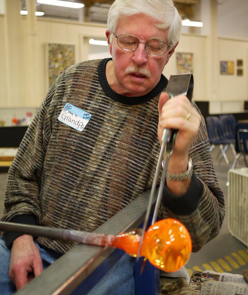 Grandpa immersed in shaping his paperweight. You have to make a groove so that we can file it off later.