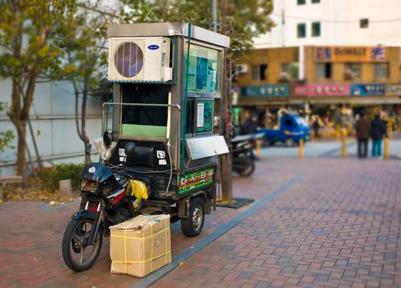 Above is a three wheeled mobile shipping office complete with Air Con…yes, there is a guy sitting in there waiting to process your shipment.