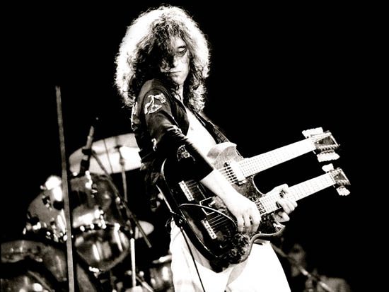 Jimmy Page of Led Zeppelin with Gibson’s double necked SG (EDS-1275), “the coolest guitar in rock”…do you know Stairway to Heaven? …Jimmy used this to play live without the cumbersome switching of guitars midway through Led Zeppelin’s signature song…that’s innovation!